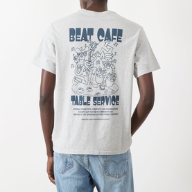 Model wearing grey marl T-shirt with navy Beat Cafe Table Service graphic print on back, styled with light wash jeans