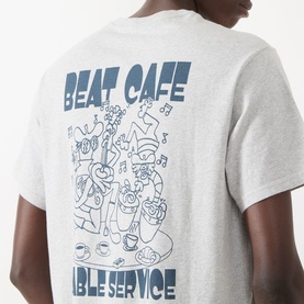 Model wearing grey T-shirt with blue Beat Cafe graphic print on back, short sleeves, relaxed fit