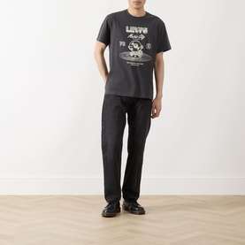 Model wearing Levi's Music City 2 Phantom crew neck T-shirt with graphic print, styled with black trousers and loafers