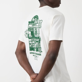 Model wearing Levis Crew Neck T in Egret, back view showing green Levi's Music City graphic print