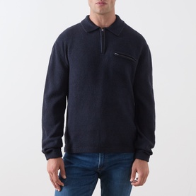 Model wearing Levi's Boulder Half-Zip Polo Sweater in navy, featuring zip chest pocket and polo collar, styled with blue jeans.
