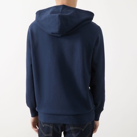 Model wearing Levi's navy hoodie in French Terry cotton, shown from the back, styled with blue denim jeans.
