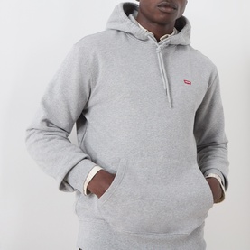 Model wearing Levi's hoodie in medium vintage heather grey, with kangaroo pocket and small red logo tab on chest