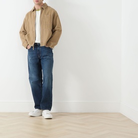 Model wearing Levi's 3049 Loose Jeans in Hard Rain dark blue denim, styled with a tan jacket and white trainers.