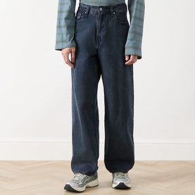 Model wearing Levi's 578&trade; Baggy Straight Leg Jeans in Time Forest dark blue denim, styled with a plaid shirt and grey trainers.