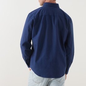Model wearing Levi's Medieval Blue Garment Dye Reg Shirt, rear view, 100% cotton, styled with light wash jeans.