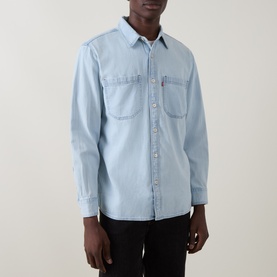 Model wearing Levi's light wash denim reg shirt with two chest pockets and long sleeves