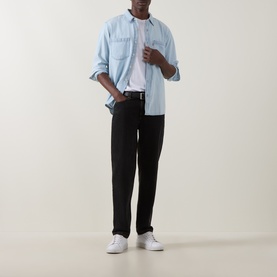 Model wearing Levis Reg Shirt in Luisa Light Wash denim, styled with white tee, black trousers and white trainers.
