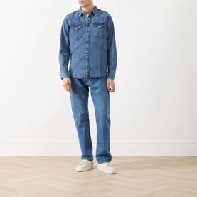 Model wearing Levi's Rustic Root Hills Worn-In denim regular shirt, styled with matching blue jeans and white trainers.