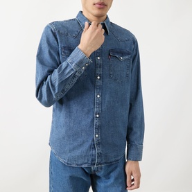 Model wearing Levi's Reg Shirt in Rustic Root Hills Worn-In denim, long sleeve with button front and chest pockets, styled with blue jeans