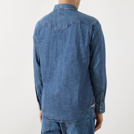 Model wearing Levi's Reg Shirt in Rustic Root Hills Worn-In denim, rear view, with long sleeves and western yoke detail