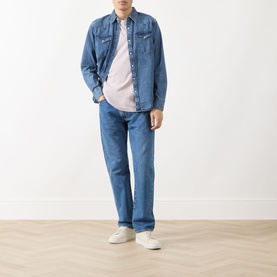 Model wearing Levi's Rustic Root Hills Worn-In denim reg shirt, styled with mid-blue jeans and white trainers