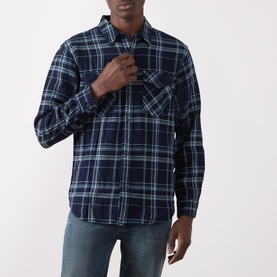 Model wearing Levi's Indigo Plaid Western Reg Shirt in navy check cotton, styled with blue jeans and a teal layering tee