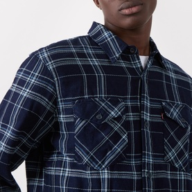 Model wearing Levi's Indigo Plaid Western Reg Shirt in navy and teal check, with chest pockets and classic collar detail.