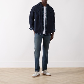 Model wearing Levi's Pier 100 Indigo Plaid Western Reg Shirt, styled with dark denim jacket, blue jeans and white trainers.