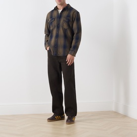 Model wearing Levi's Reg Shirt in Toby Vintage Indigo check, styled with dark trousers and brown trainers.