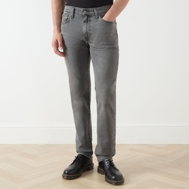 Model wearing Levi's 3049 Slim Jeans in Granite Shadow grey denim, styled with black leather lace-up boots.