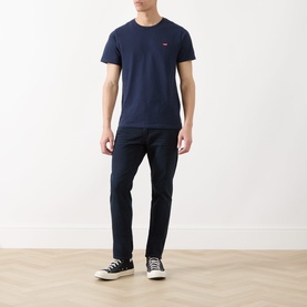 Model wearing Levi's 511&trade; Slim Leg Jeans in Why So Blue dark wash, styled with a navy tee and black high-top trainers.