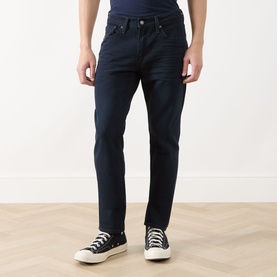 Model wearing Levi's 511&trade; Slim Leg Jeans in Why So Blue dark wash, slim-leg fit, styled with black low-top trainers.