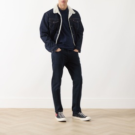 Model wearing Levis 511&trade; Slim Leg Jeans in Why So Blue dark wash, styled with a sherpa denim jacket and black high-top trainers.