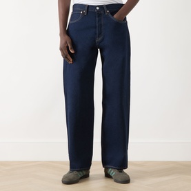 Model wearing Levi's 3049 Straight Jeans in Keep It Forever Rinse dark indigo wash, relaxed fit, styled with grey trainers.
