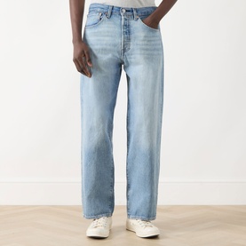 Model wearing Levi's 501&reg; Loose Jeans in In My Bronco, light wash straight-leg denim with button fly, styled with white trainers.