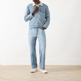 Model wearing Levis 501&reg; Loose Jeans in In My Bronco light wash straight-leg denim, styled with a denim jacket and white trainers