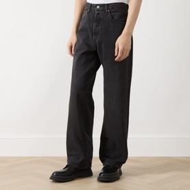Model wearing Levi's 3049 Straight Jeans in Big Wheels dark wash black denim, paired with black leather shoes.