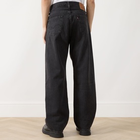 Model wearing Levi's Big Wheels straight jeans in washed black, rear view showing relaxed wide-leg fit and classic five-pocket styling