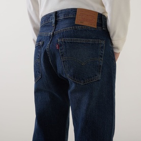 Model wearing Levi's 3049 Straight Jeans in Terra Linda dark wash denim, rear view showing leather patch and red tab detail.