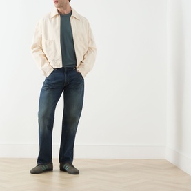 Model wearing Levis 3049 Straight Jeans in Advice To You dark wash denim, styled with cream harrington jacket and grey tee.