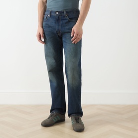 Model wearing Levi's 3049 Straight Jeans in Advice To You mid-blue wash denim, styled with grey trainers.