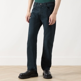 Model wearing Levi's 3049 Straight Jeans in City Boy Blues, dark teal cotton denim, styled with black leather shoes