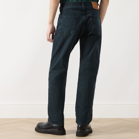 Model wearing Levi's 3049 Straight Jeans in City Boy Blues, dark indigo wash, 100% cotton, styled with black leather shoes, rear view.