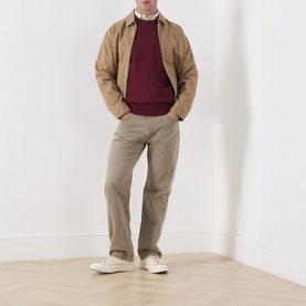 Model wearing Levis 3049 Straight Jeans in Salty Capers, styled with a burgundy knit, tan harrington jacket and white trainers.