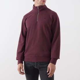 Model wearing Levi's quarter-zip sweatshirt in wine marl French Terry cotton, styled with dark jeans.