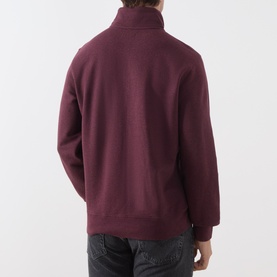 Model wearing Levi's sweatshirt in winetasting mauve, rear view showing ribbed cuffs, hem and funnel neck zip collar.