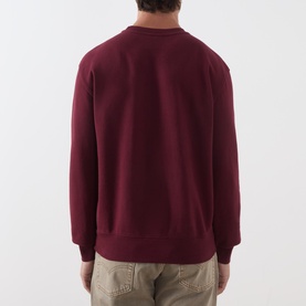 Model wearing Levi's Tawny Port cotton crew neck sweatshirt, back view, styled with beige trousers.