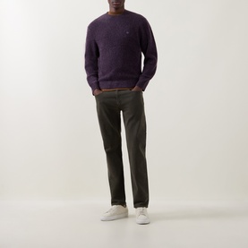 Model wearing Levis 3049 Tapered Jeans in Redwood Bough, styled with a purple crew-neck jumper and white trainers.