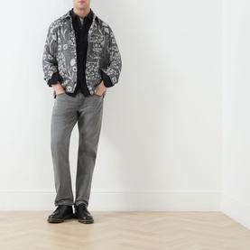 Model wearing Levis 3049 Tapered Jeans in Granite Shadow, styled with a grey printed jacket and black loafers.