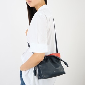 Model carrying Loewe Flamenco Mini Clutch in Multicolour Deep Navy calfskin, with red interior contrast, silver-tone hardware and crossbody strap.
