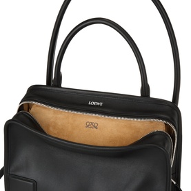Loewe Amazona 180 Medium Top Handle Bag in black smooth calfskin, open to reveal suede lining, with silver-tone zip and top handles visible.