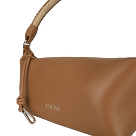Loewe mocha lambskin top handle bag, close-up showing silver logo lettering, knotted handle detail and lobster clasp hardware.