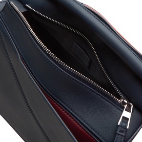 Loewe Puzzle Edge Small Crossbody Bag in Multicolour Deep Navy, interior view showing zip pocket, red lining, and embossed logo detail