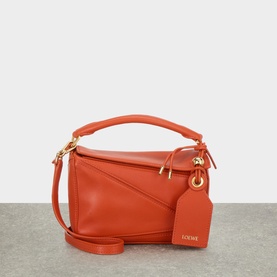 Loewe Deep Saffron nappa lambskin top handle bag with gold-tone hardware, geometric seam detail, and detachable crossbody strap