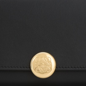 Loewe black nappa calfskin wallet with circular gold-tone Anagram logo clasp, close-up detail shot