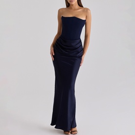 Model wearing House of CB navy strapless maxi dress with ruched side detail and fitted silhouette