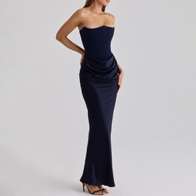 Model wearing House of CB navy strapless maxi dress with ruched satin skirt and fitted corset bodice
