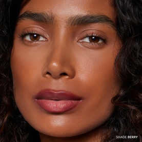 Model wearing REFY Blur Liner in shade Berry, shown as a close-up beauty shot with defined matte berry-toned lips.
