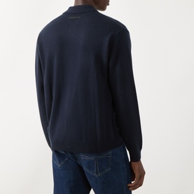 Model wearing Seven Jeans Cashmere Knitted Polo Shirt in Midnight, rear view, styled with blue denim jeans